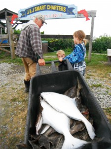 Savannah and Hunter helping Grandpa carry halibut from the HERS TOO!