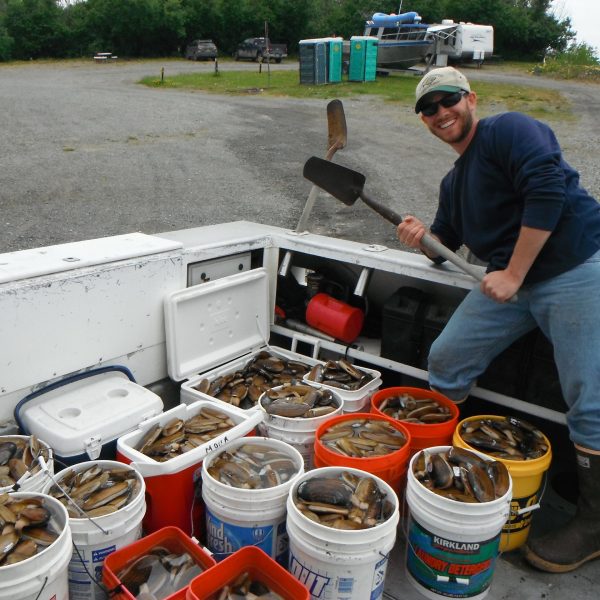 Capt Mike posing with many buckets of clams