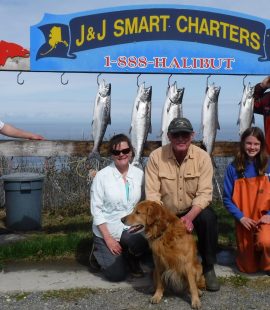 Fishing charter participants posing with their catch