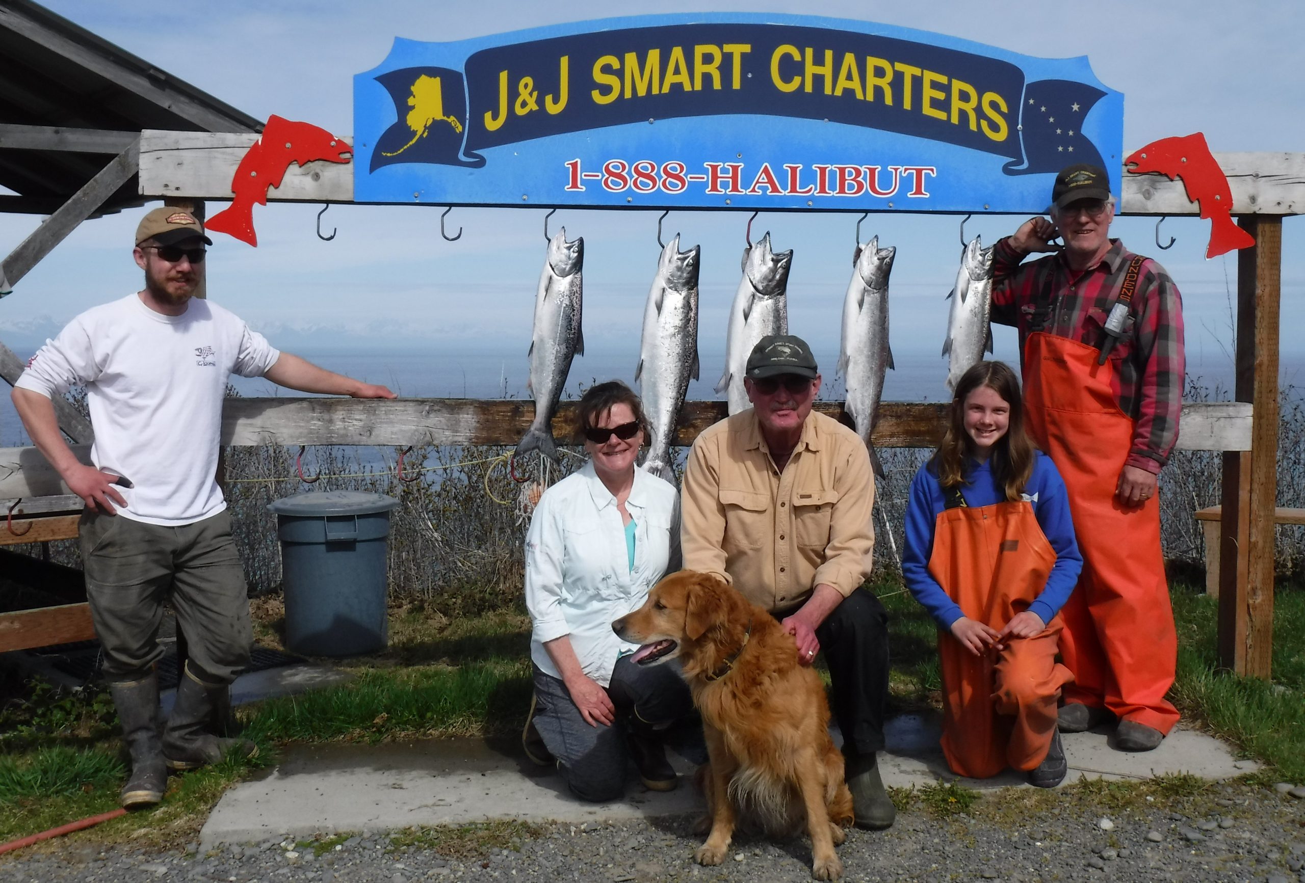 Fishing charter participants posing with their catch
