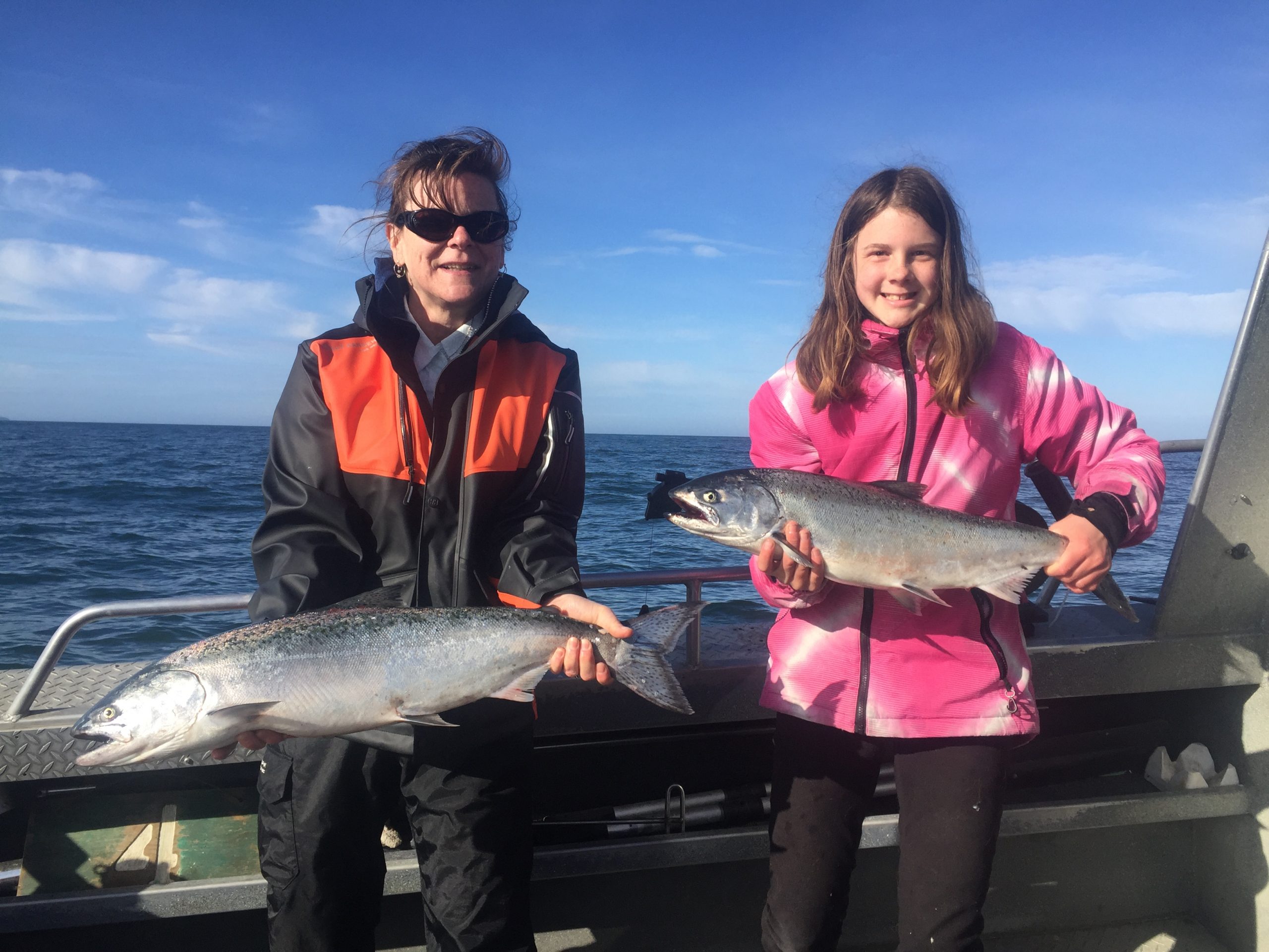 Fishing charter participants posing with their catch