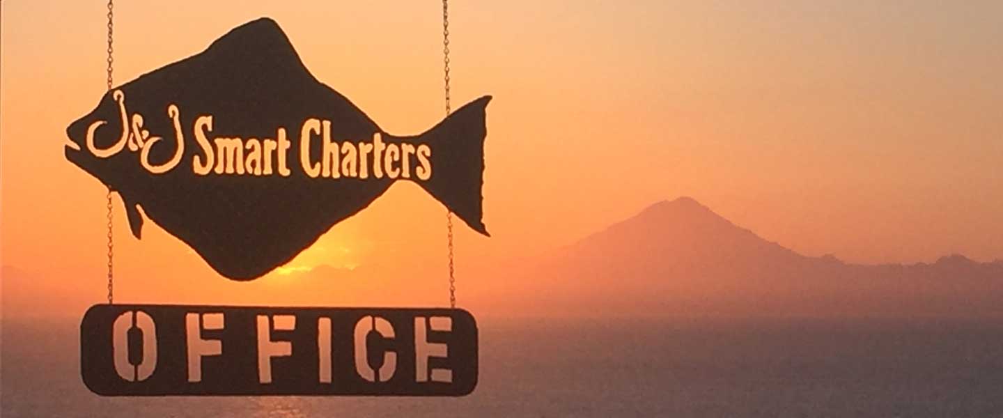 Our campground office sign with a sunset and mountain in the background