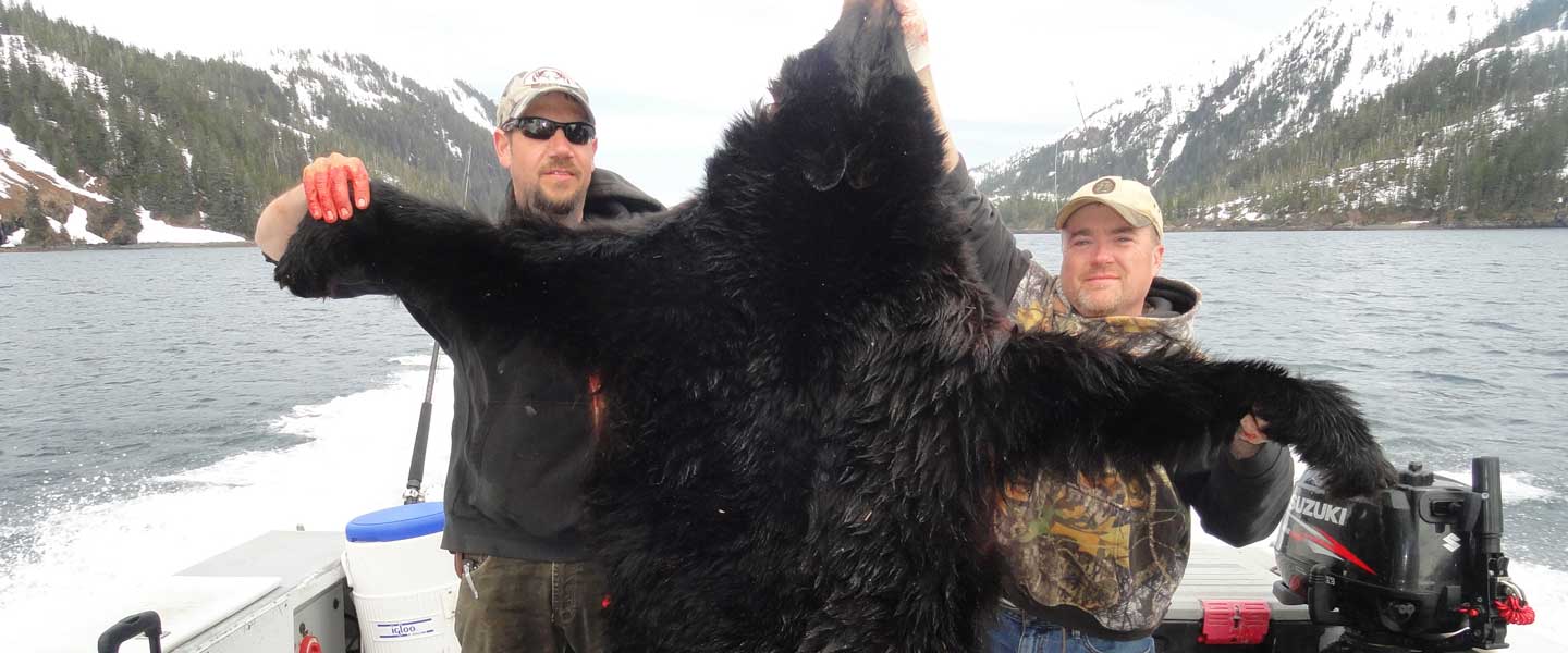 Bear hunters posing with a bear
